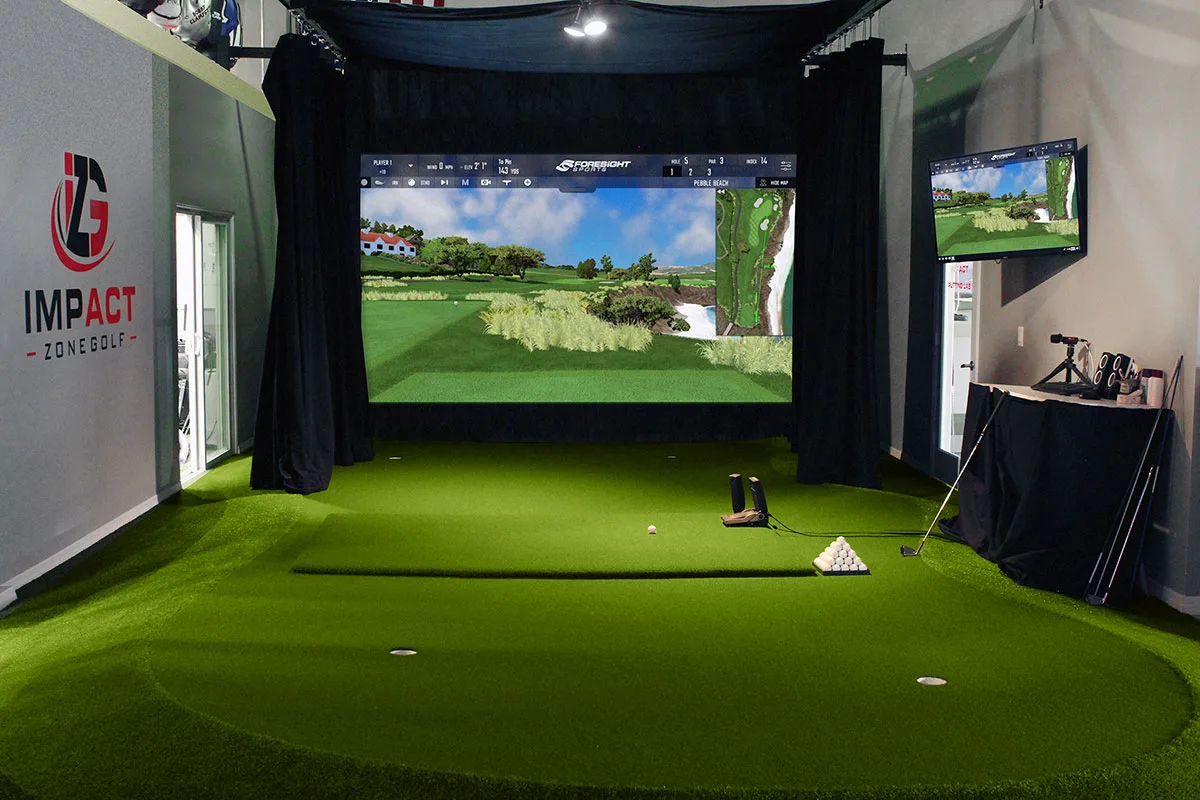 Indoor golf simulator bay with Foresight Sports technology at Impact Zone Golf